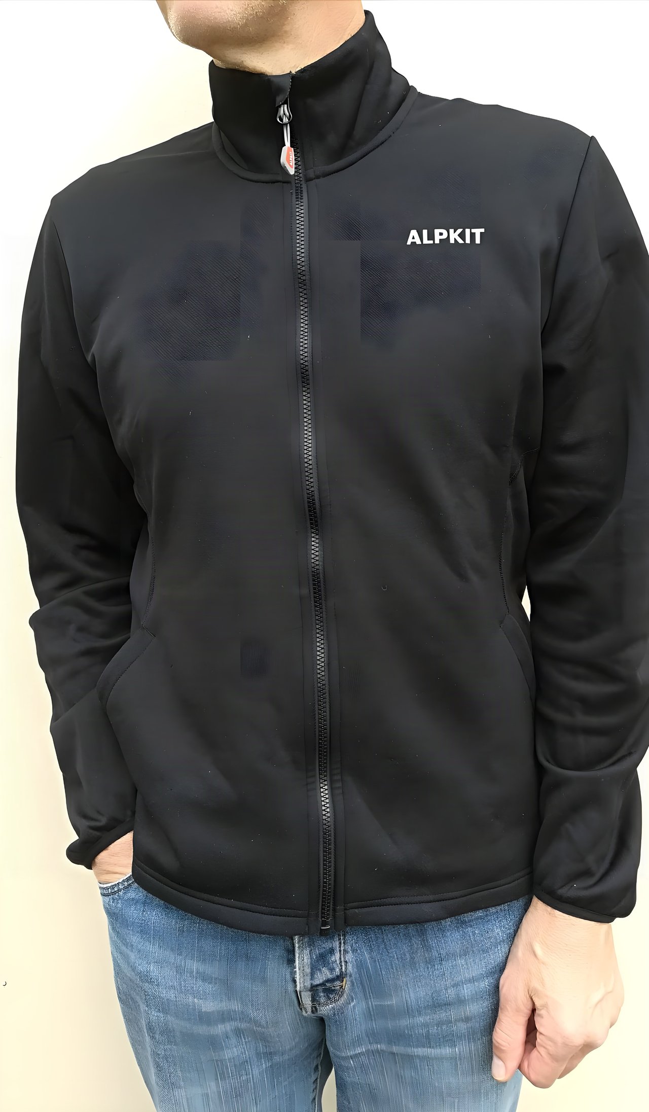 Alpkit Akita fleece jacket in black, worn zipped up with a chunky full-length zip and Alpkit logo on the chest.