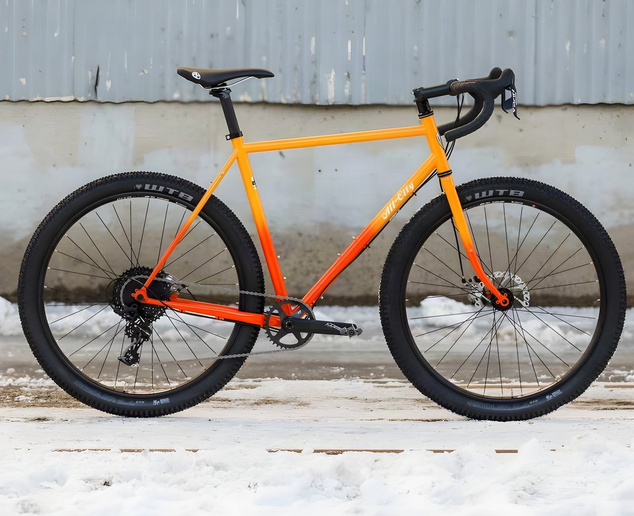All City Gorilla Monsoon monster-cross bike in orange fade paint, side view, with WTB tyres and a one-by drivetrain.