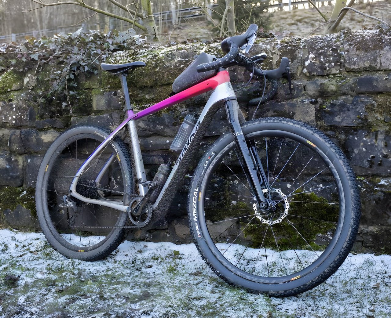 Salsa Cutthroat built for the Dirty Reiver leans on a mossy stone wall above snowy grass, Vittoria Mezcal tyres fitted.