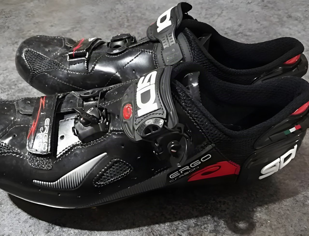 Pair of black Sidi Ergo 4 Carbon road shoes with dial and strap closures, seen from the side.