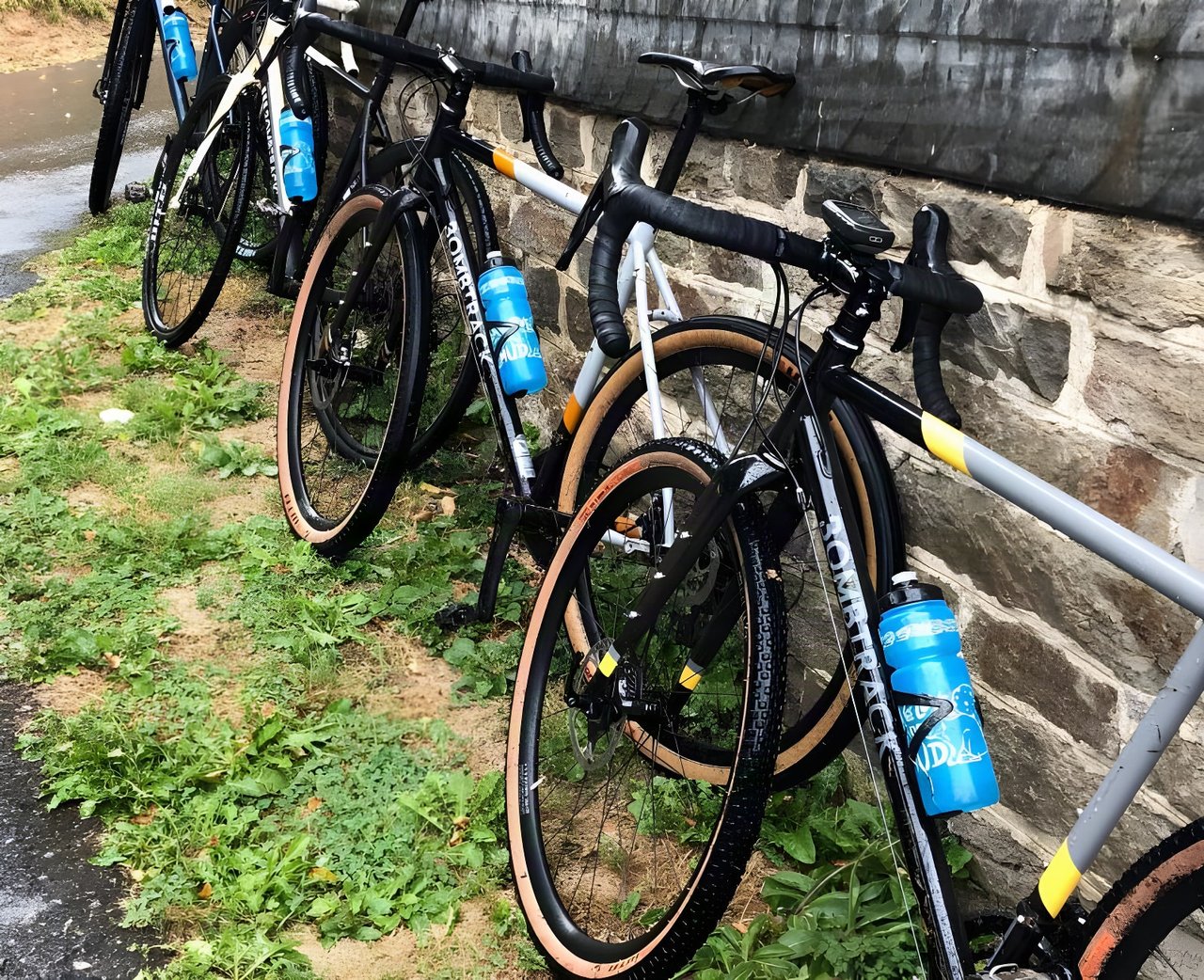 Bombtrack gravel bikes with tan-wall tyres leant against a stone wall at the Groundwork press event near Cologne.