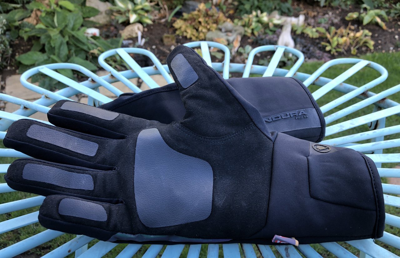 Endura Pro SL Primaloft waterproof gloves in black on a garden chair, one palm up showing the rubberised grip patches.