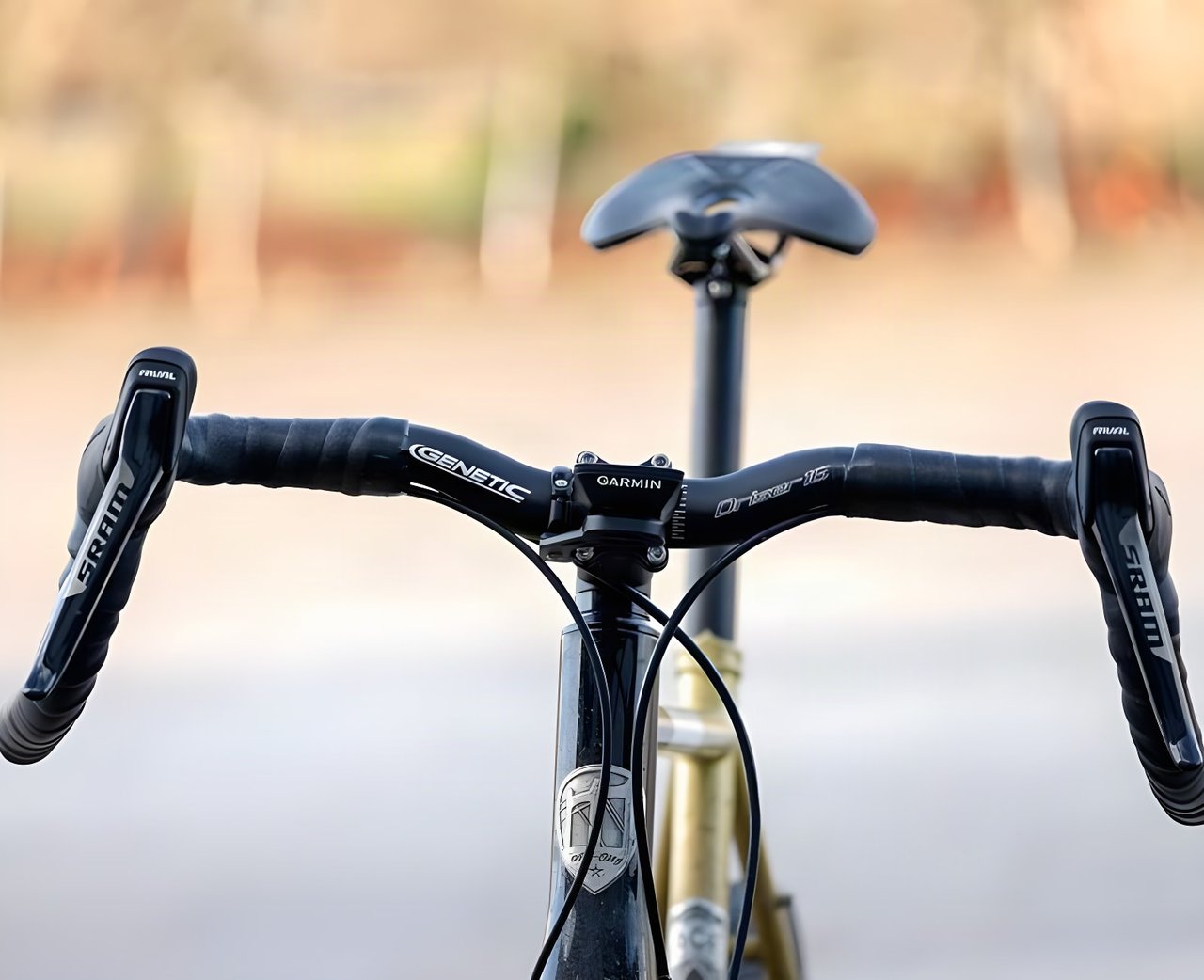 Genetic Driser 16 drop bars wrapped in black tape, with SRAM Rival levers and a Garmin mount, seen head-on.