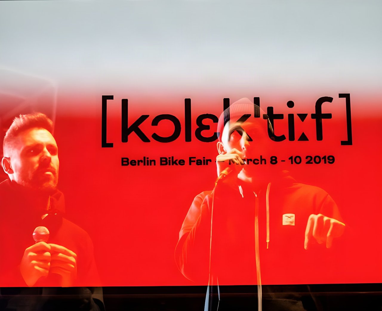 Speakers on stage in front of the Kolektif Berlin Bike Fair sign for 8-10 March 2019.