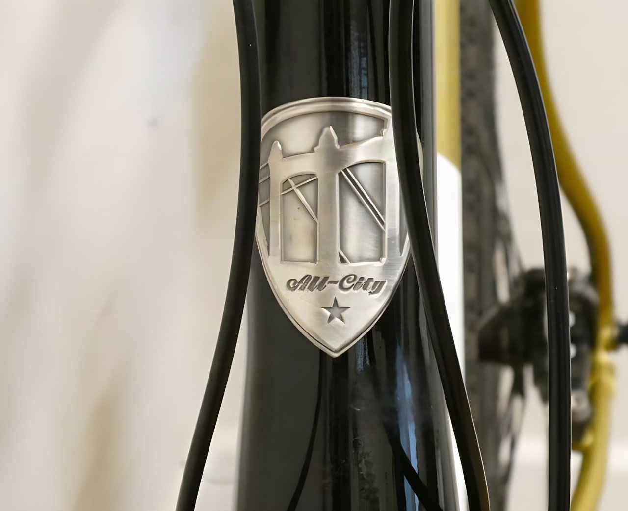 Close-up of the All-City head badge on the steel frame of the Cosmic Stallion.