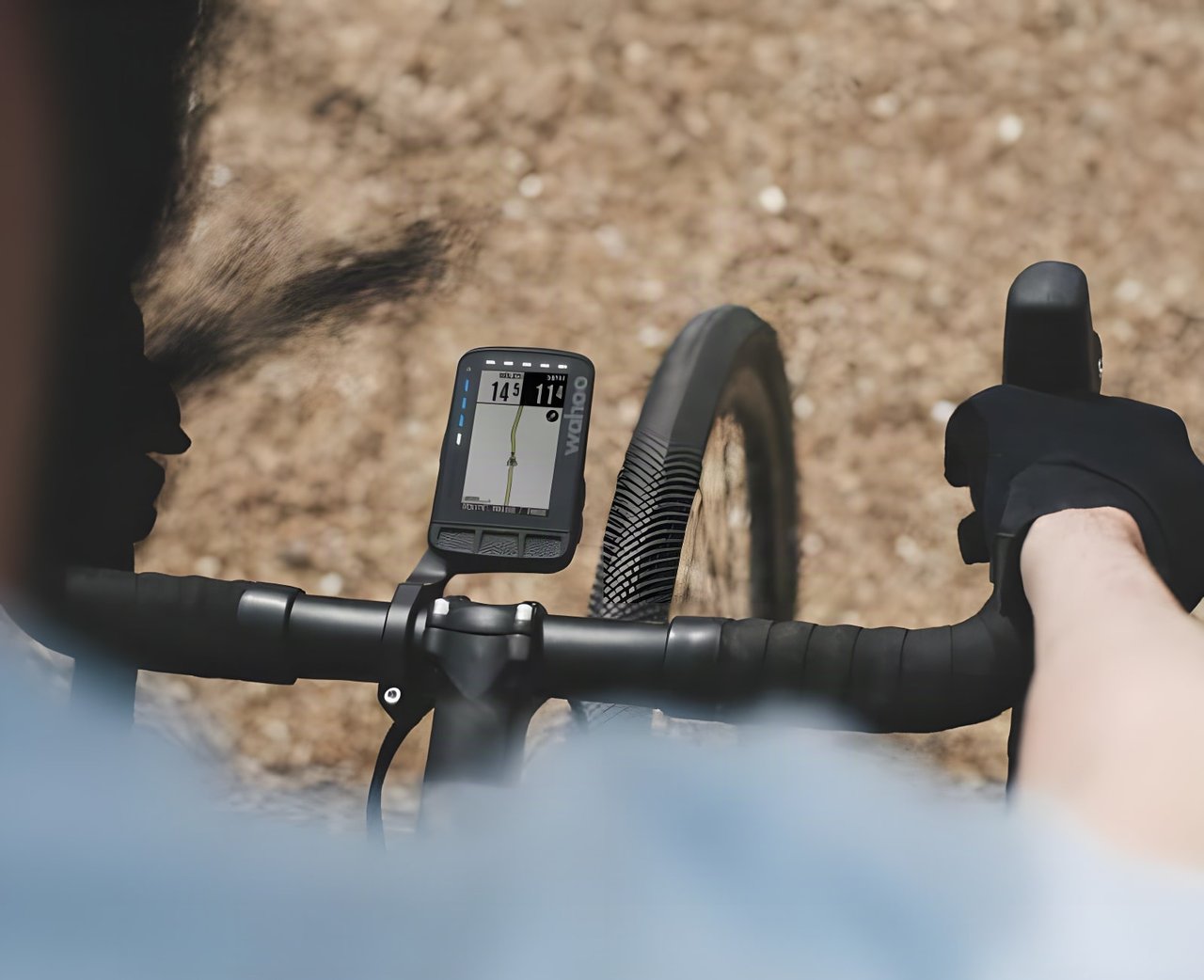 A Wahoo ELEMNT ROAM GPS computer mounted on a gravel bike's handlebars, viewed from above.