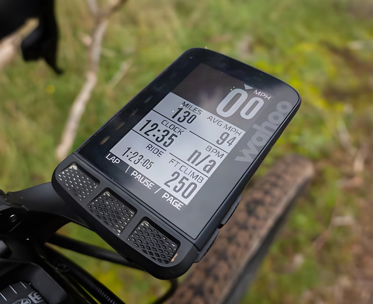 Wahoo ELEMNT ROAM bike computer on a handlebar mount, showing speed, distance, clock and climb data.