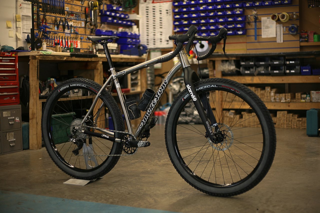 Smokestone Mr Harry titanium drop-bar bike on Vittoria Mezcal tyres with a Whisky fork, in the Slam 69 workshop.