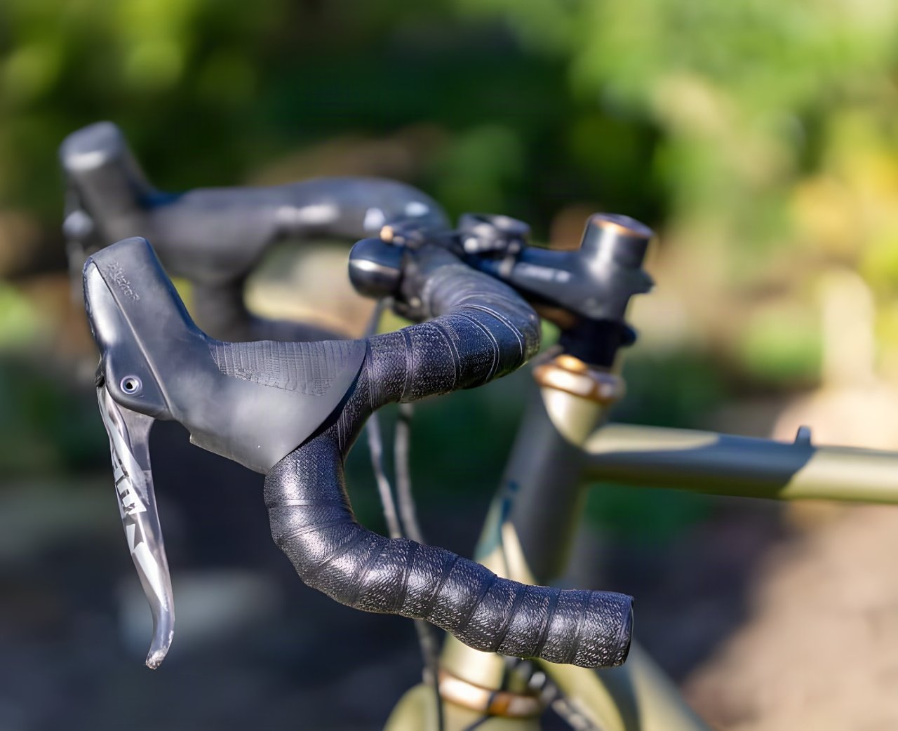 Ritchey WCS Carbon VentureMax bar with a SRAM Force lever and black tape, in close-up on a gravel bike.
