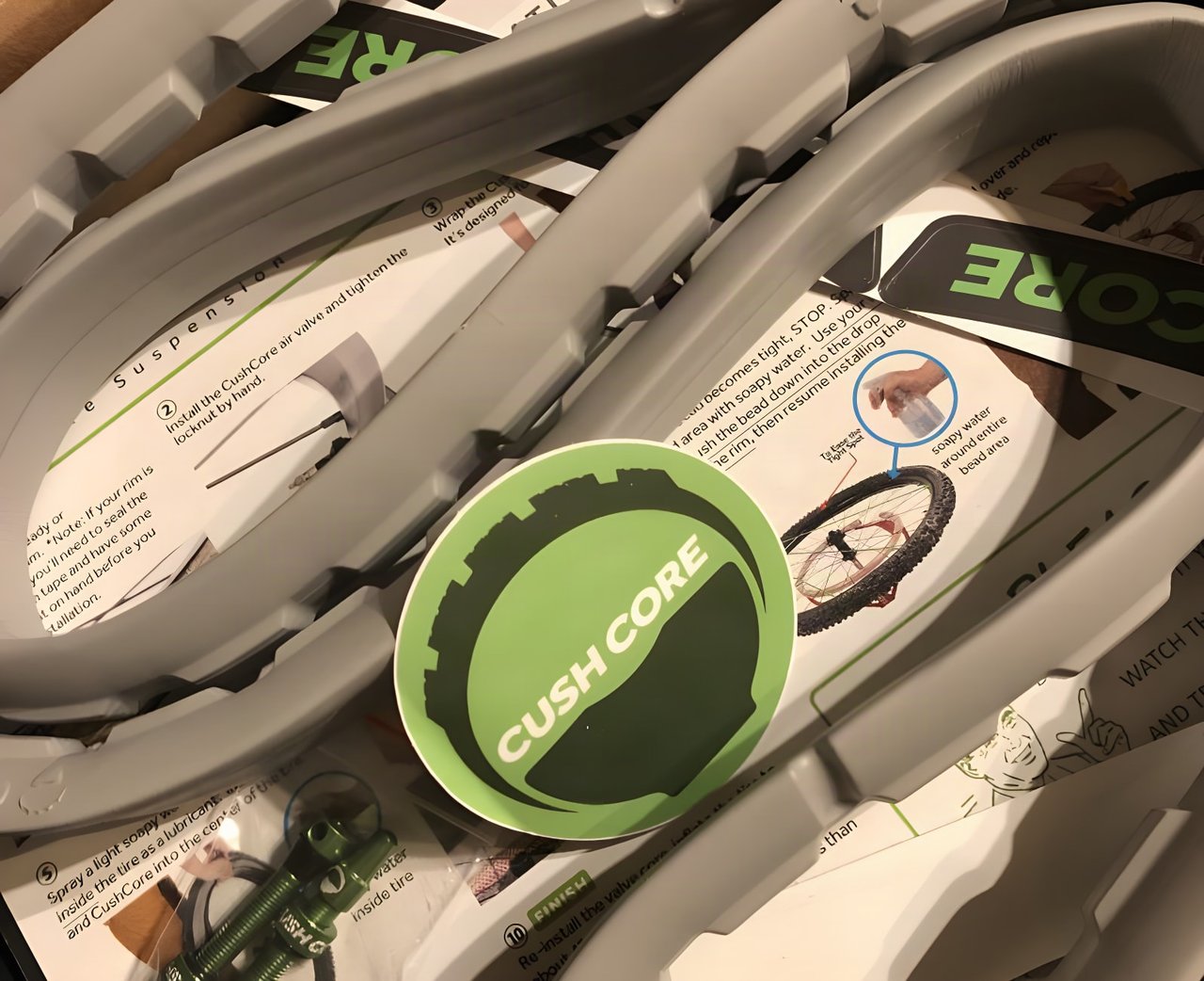 CushCore Gravel-CX tyre inserts in their box with instruction sheets, a green CushCore sticker and valves.