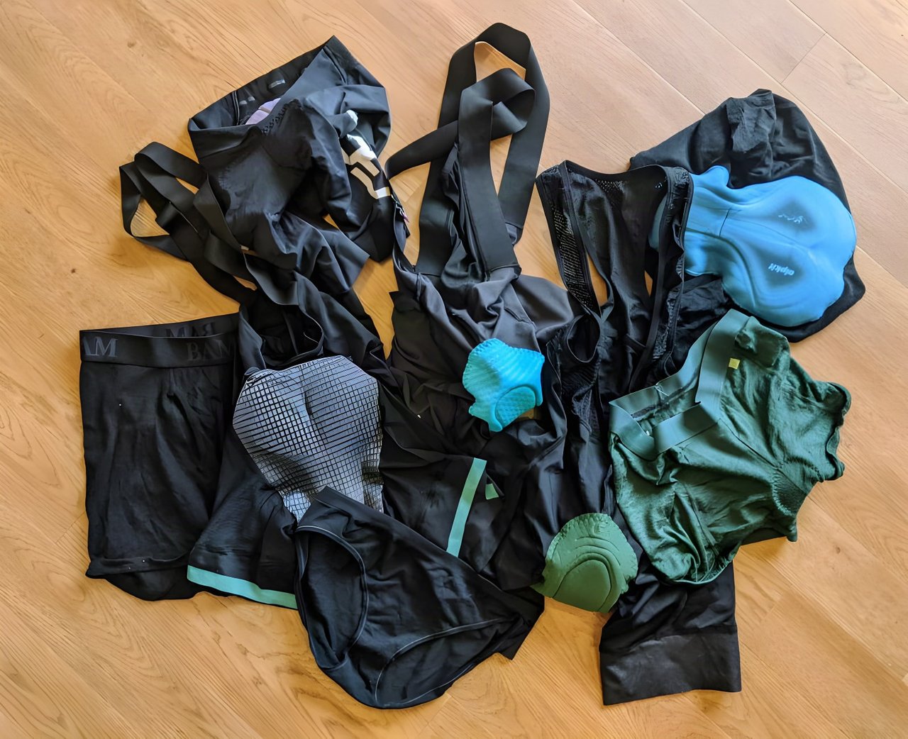 Pile of padded liner shorts, bib shorts and underwear in black and green, the options for wearing under baggies.