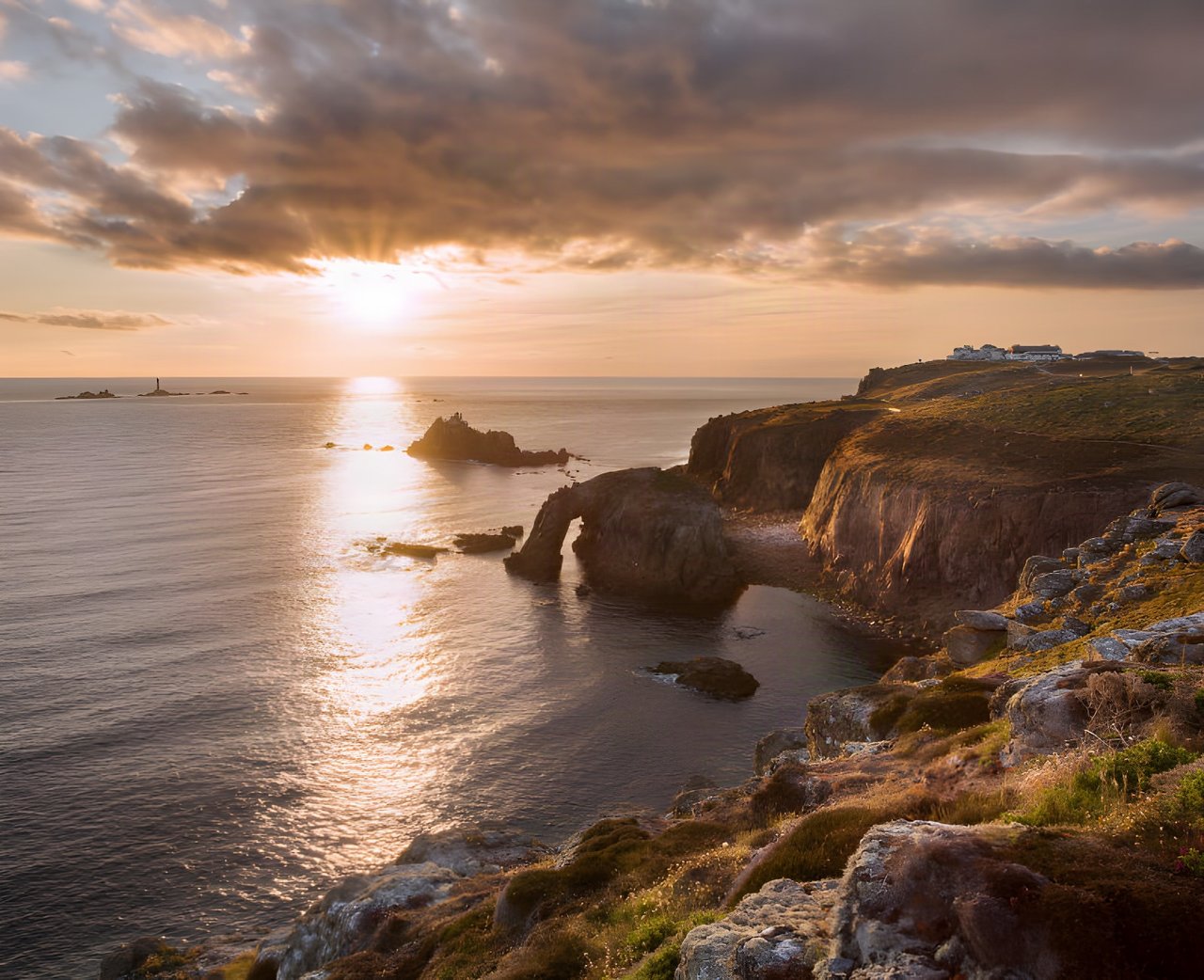 Sunset over the sea and cliffs at Land's End in Cornwall, the Celtic nation where the Pan Celtic Race 2021 starts.