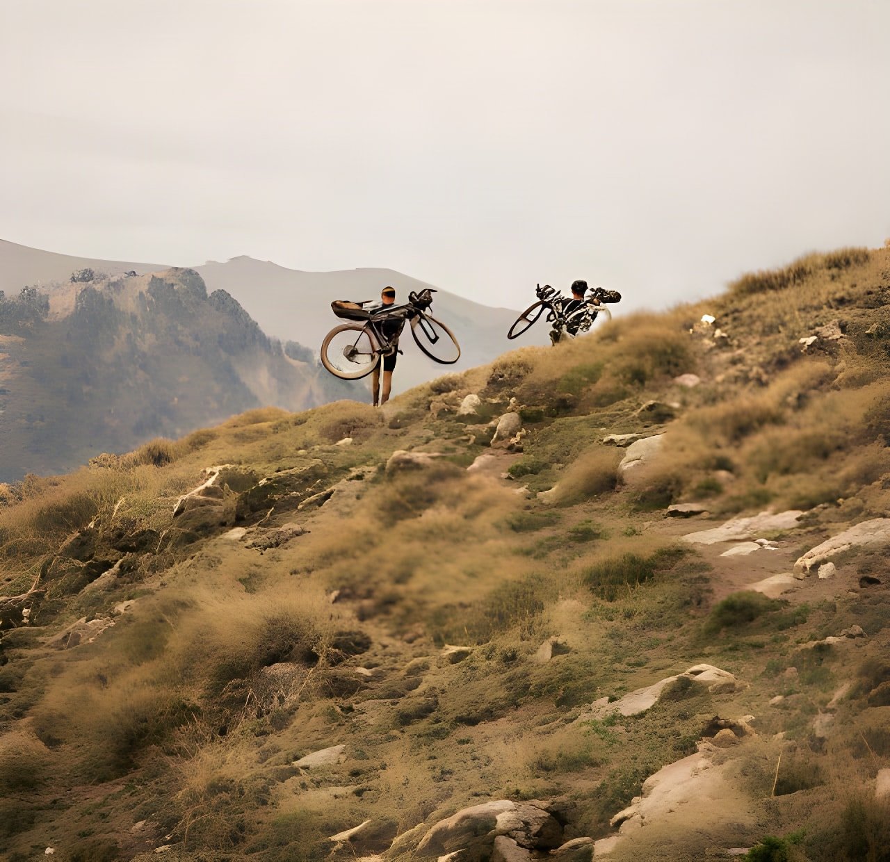 Svein Tuft and Christian Meier shoulder loaded bikes up a rocky Pyrenean hillside in the short film Connection.