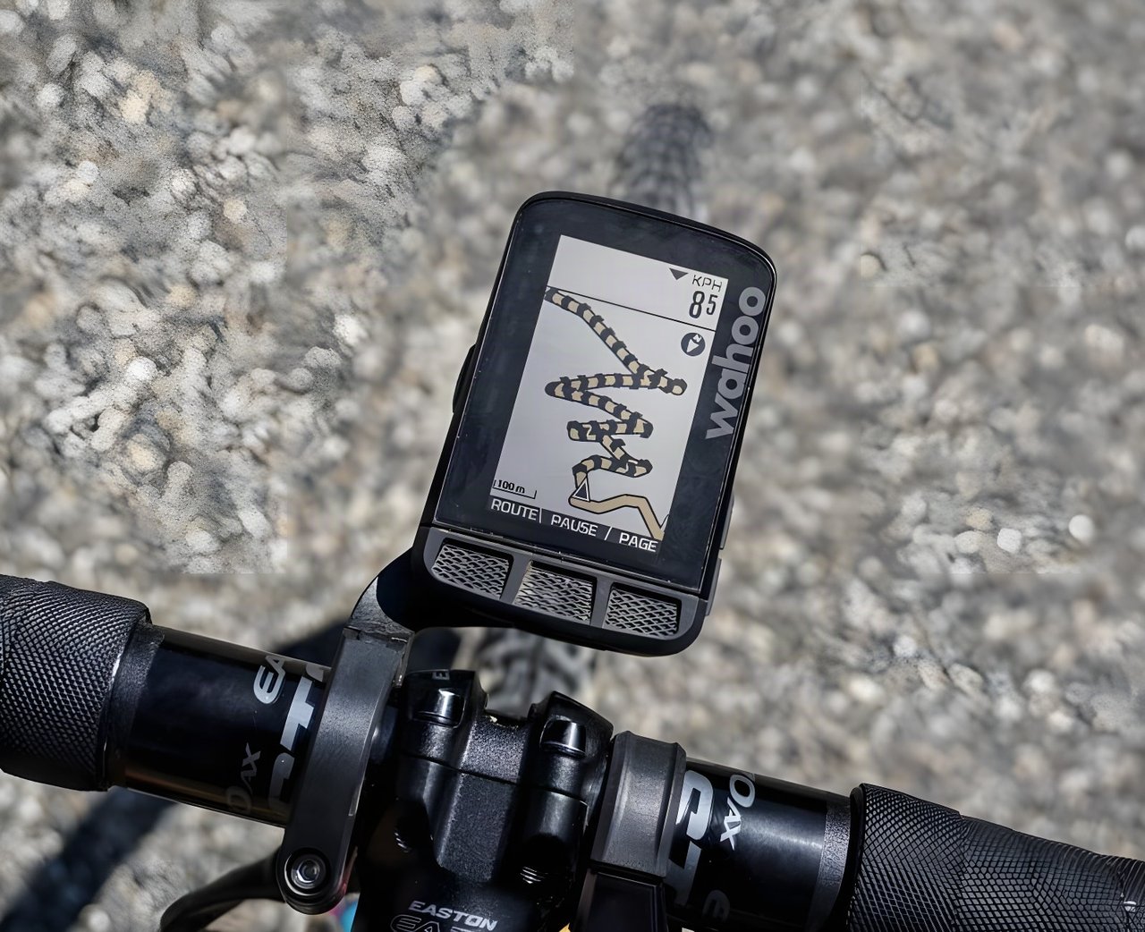 Wahoo ELEMNT ROAM showing a route map on a bike's out-front mount, with coarse gravel below.