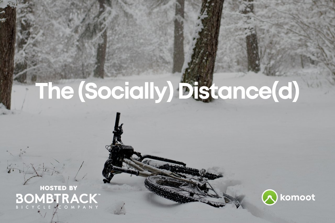 The (Socially) Distance(d) 2021 poster: a bike lying in deep snow among trees, with Bombtrack and komoot logos.