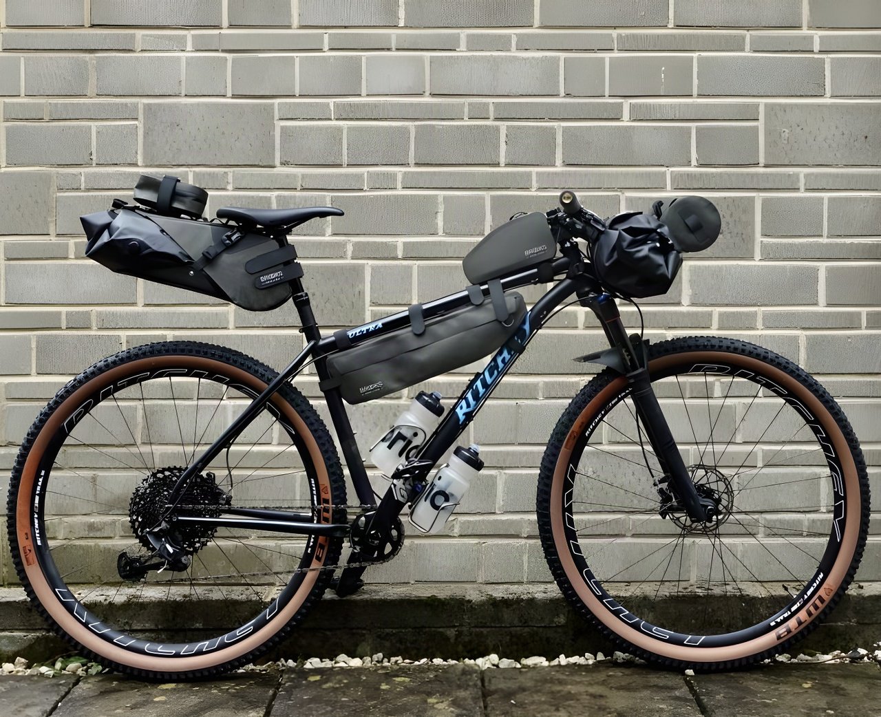 Ritchey mountain bike loaded with Brooks Scape bikepacking bags: seat pack, frame bag, top tube bag and handlebar roll.