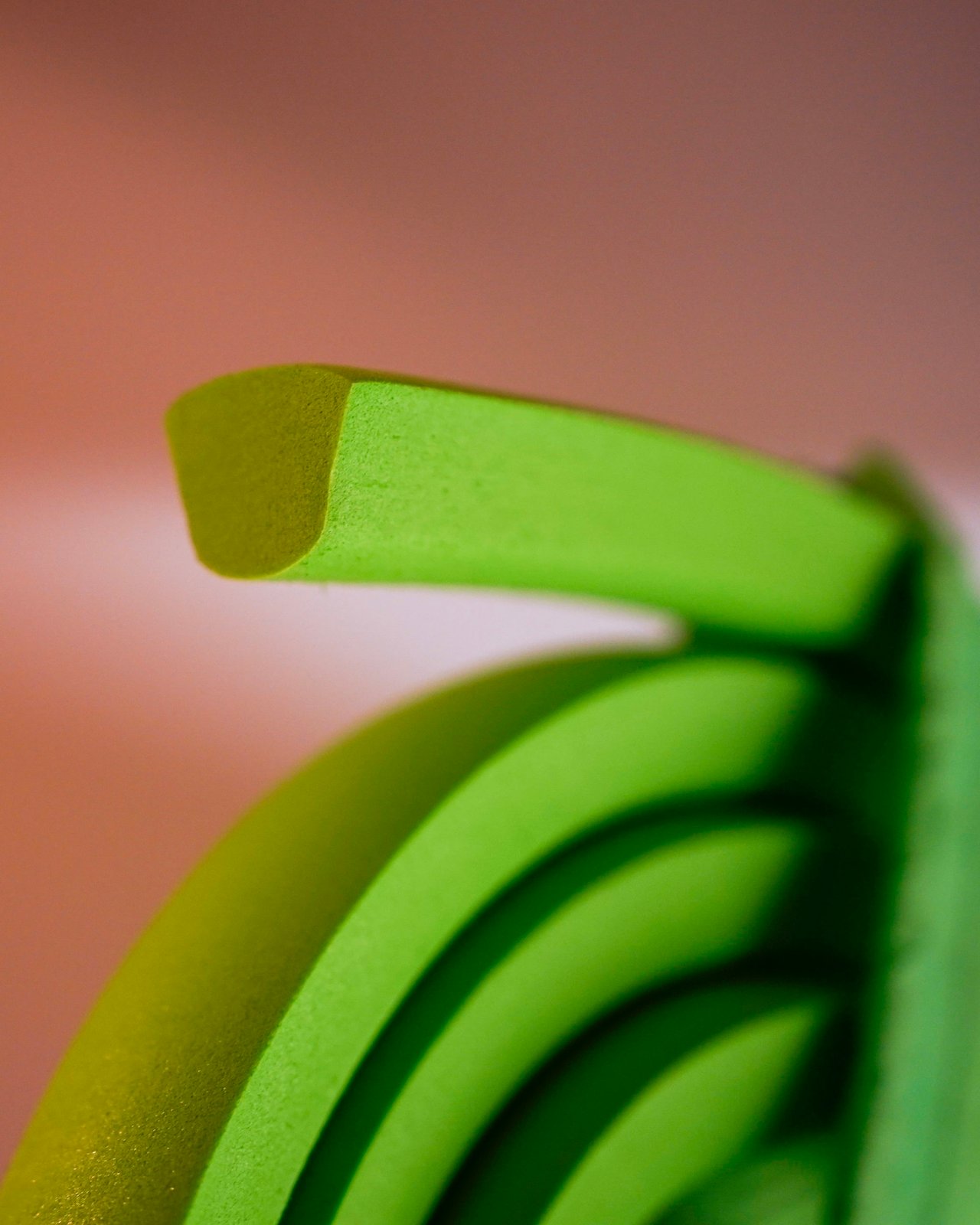 Close-up of the green EVA foam profile of the Vittoria Air-Liner Gravel tyre insert, curled in a loop.