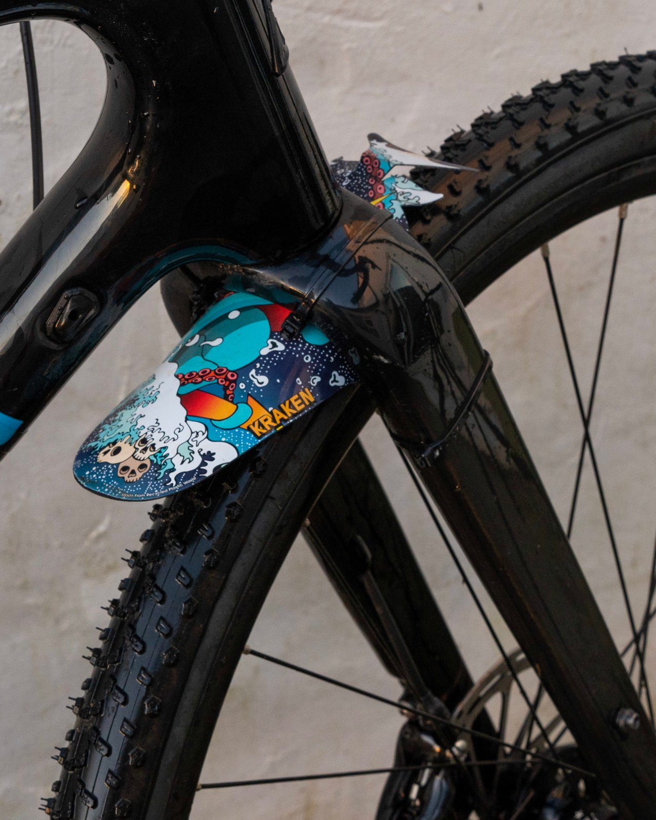 RideGuard Vision front guard in Kraken design zip-tied to the fork of a black gravel bike.