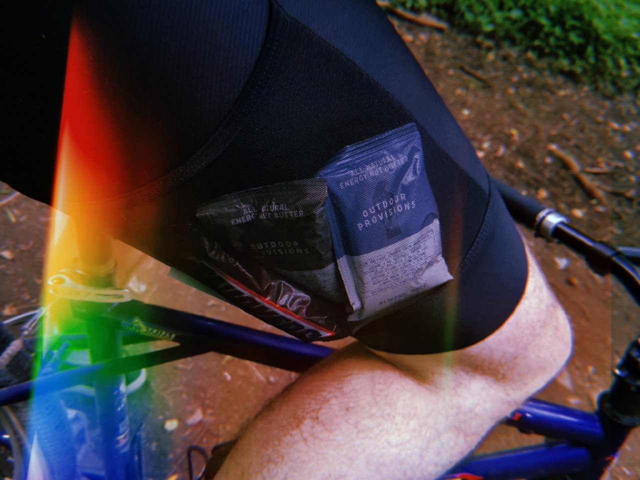 Santini Gravel Bib cargo shorts with energy nut butter sachets tucked in the mesh thigh pocket while riding.
