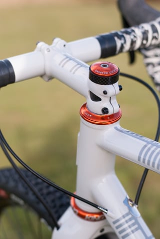 Stem, red Chris King headset and camo bar tape on the Donard x Victory Chimp, with Ogham stripes on the top tube.