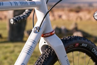 Donard head tube close-up with red King headset, stainless cable entry point and WTB Nano 27.5 tyre.