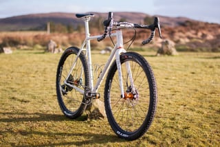 Donard x Victory Chimp Gairbhéal bike from the front quarter, with orange Hope hubs and 27.5-inch WTB Nano tyres.
