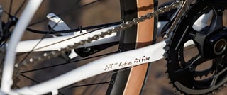 Surly Midnight Special chainstay with "fatties fit fine" lettering beside the chain and chainrings.