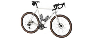 Surly Midnight Special build with two bottle cages and a saddlebag, three-quarter view on white.