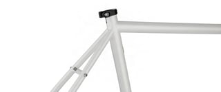 Surly Midnight Special seat tube junction with seat clamp and bridged seatstays on the white frame.