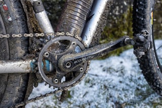 Mud-spattered Middleburn crank, chainring and XTR pedal on the Salsa Cutthroat, standing on snowy ground.
