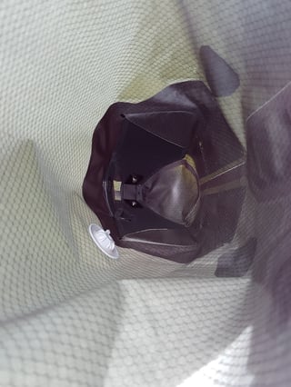 Looking inside the open Ortlieb seat pack at the plastic reinforcement and the white air-release valve.
