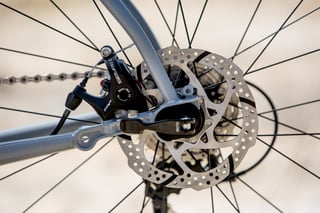 TRP Spyre C mechanical disc brake and rotor on the rear dropout of the Bombtrack Audax.