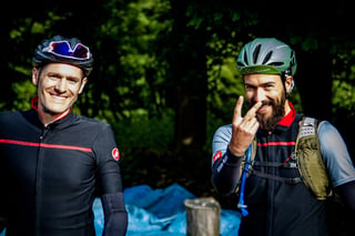 Two smiling riders in helmets and cycling kit pose for the camera among trees at Yorkshire True Grit 2018.