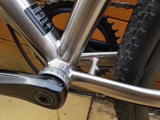 Reilly Gradient bottom bracket shell with welded titanium tubes, 3Al/2.5V decal, crank arm and gravel tyre.