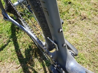 Rear triangle of the Lauf True Grit viewed from above, showing the chain, rear tyre and seat tube bolts.