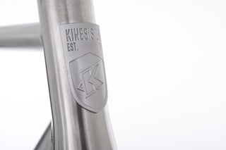 Close-up of the Kinesis UK head badge on the titanium head tube of the GTD frame.