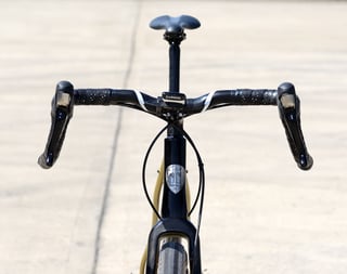 Front view of the prototype alloy riser flare drop bars with a Garmin head unit above the All-City head badge.