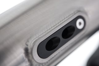 Black cable port with two entry holes on the down tube of the Kinesis GTD frame.
