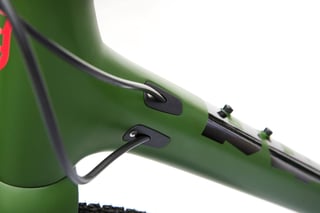 Kona Libre DL head tube in olive green, with cable ports and a cable routed into the frame.