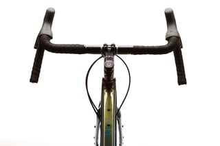 Kona Libre handlebar and stem from the front, with black bar tape and Libre lettering on the down tube.