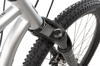 Close-up of the MRP Baxter fork crown and compression dial on the Hook ADV, with the head tube above.