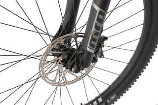 Front disc brake rotor and SRAM Rival caliper on the MRP fork of the Bombtrack Hook ADV, with a through-axle lever.