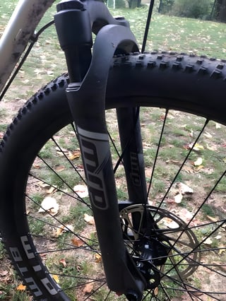 Close-up of the MRP suspension fork and WTB rim on the Bombtrack Hook ADV, with a knobbly mountain bike tyre.