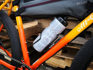 Close-up of the Gorilla Monsoon's All-City down tube with a Passport bottle cage, bottle and frame bag.