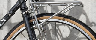 Silver front rack and tan-wall Panaracer Pasela tyre on the Surly Pack Rat.