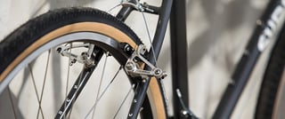 Silver Tektro rim brakes and a tan-wall tyre on the Surly Pack Rat.