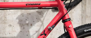 Surly Straggler MY19 frame detail in red, showing the top tube decal and Cane Creek headset.