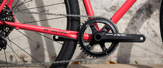 Surly Straggler's SRAM Apex 1x crankset, with fatties fit fine lettering on the red chainstay.