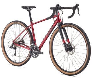 Women's Pinnacle Arkose D1 in gloss red with black fork, disc brakes and tan wall gravel tyres.