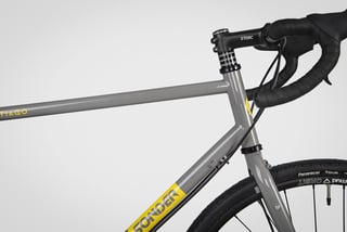 Head tube and front end of the grey Sonder Santiago with Storc stem, drop bars and a Panaracer Tour tyre.